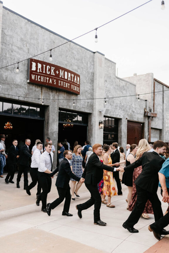 Wedding guests dance on the Brick and Mortar patio.