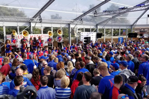 KU basketball fans in a glass tent for a party.